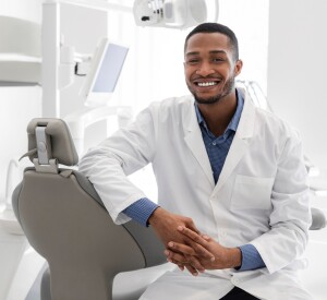 Highly,Qualified,Young,Black,Dentist,Posing,At,Clinic,Over,Modern